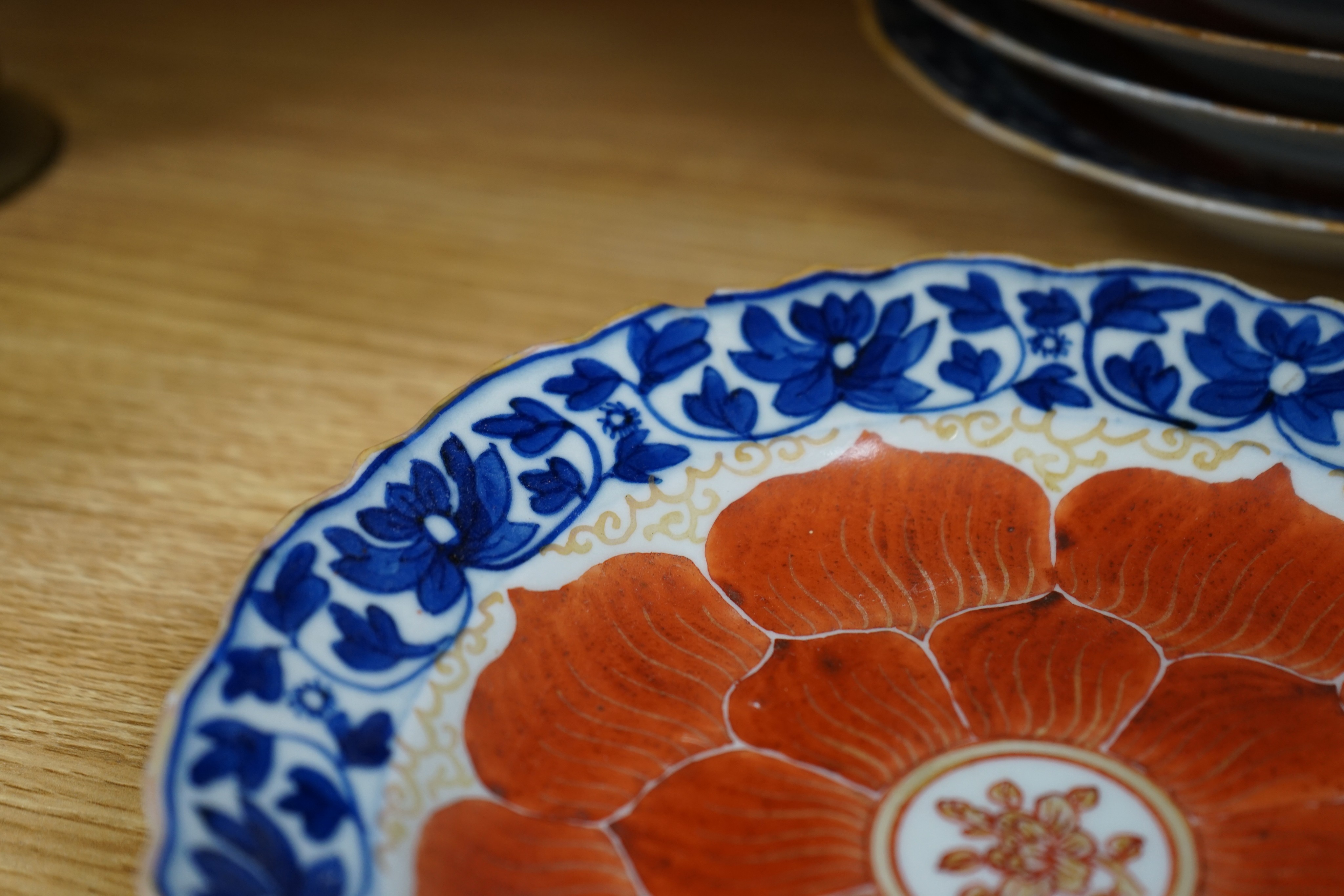A set of eight Chinese plates with orange 'lotus' centres and blue floral borders, Qing dynasty, Dia 20cm
